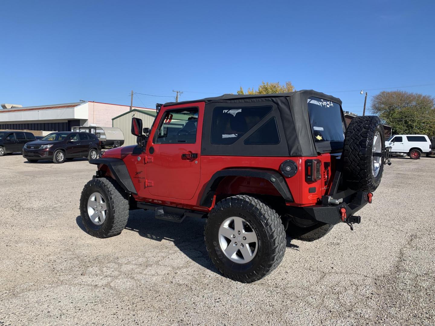 2011 Red /Black Jeep Wrangler Sport 4WD (1J4AA2D12BL) with an 3.8L V6 OHV 12V engine, Auto transmission, located at 1830 North Belt Line Road, Irving, TX, 75061, (469) 524-0199, 32.834373, -96.993584 - Photo#3