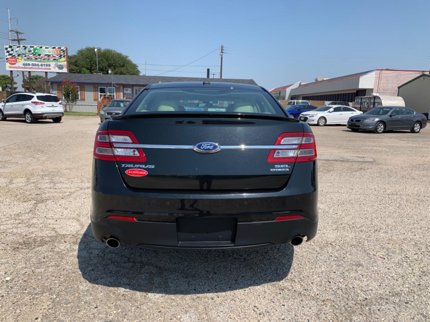 2014 Black /Tan Ford Taurus SEL FWD (1FAHP2E88EG) with an 3.5L V6 DOHC 24V engine, Automatic transmission, located at 1830 North Belt Line Road, Irving, TX, 75061, (469) 524-0199, 32.834373, -96.993584 - Photo#2