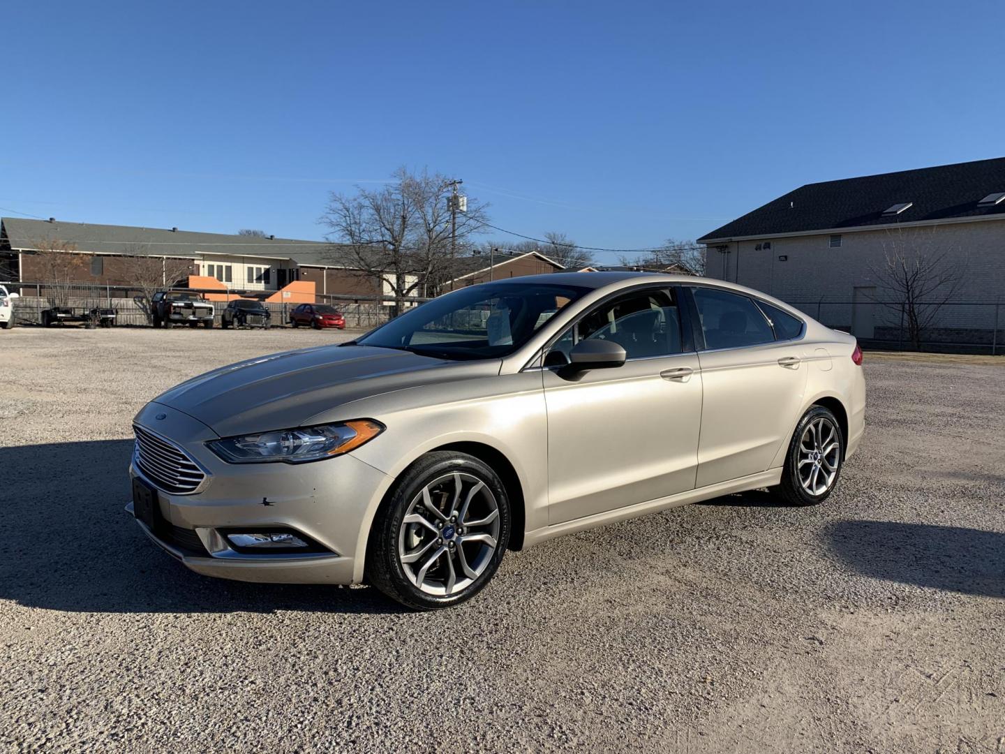 2017 Gold /Black Ford Fusion SE (3FA6P0H7XHR) with an 2.5L L4 DOHC 16V engine, AUTOMATIC transmission, located at 1830 North Belt Line Road, Irving, TX, 75061, (469) 524-0199, 32.834373, -96.993584 - Photo#2