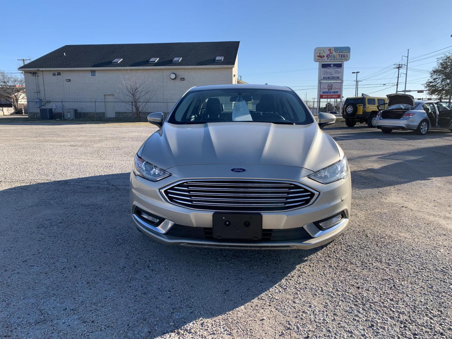 2017 Gold /Black Ford Fusion SE (3FA6P0H7XHR) with an 2.5L L4 DOHC 16V engine, AUTOMATIC transmission, located at 1830 North Belt Line Road, Irving, TX, 75061, (469) 524-0199, 32.834373, -96.993584 - Photo#1